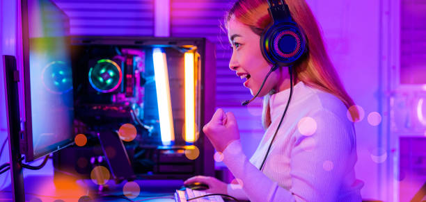 asian gamer playing online video game excited on desktop computer - 电竞 個照片及圖片檔