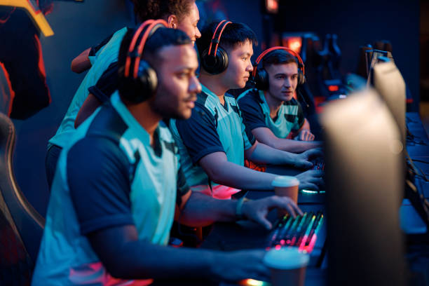 cyber sportsmen participating in important match at gaming club - 电竞选手 個照片及圖片檔
